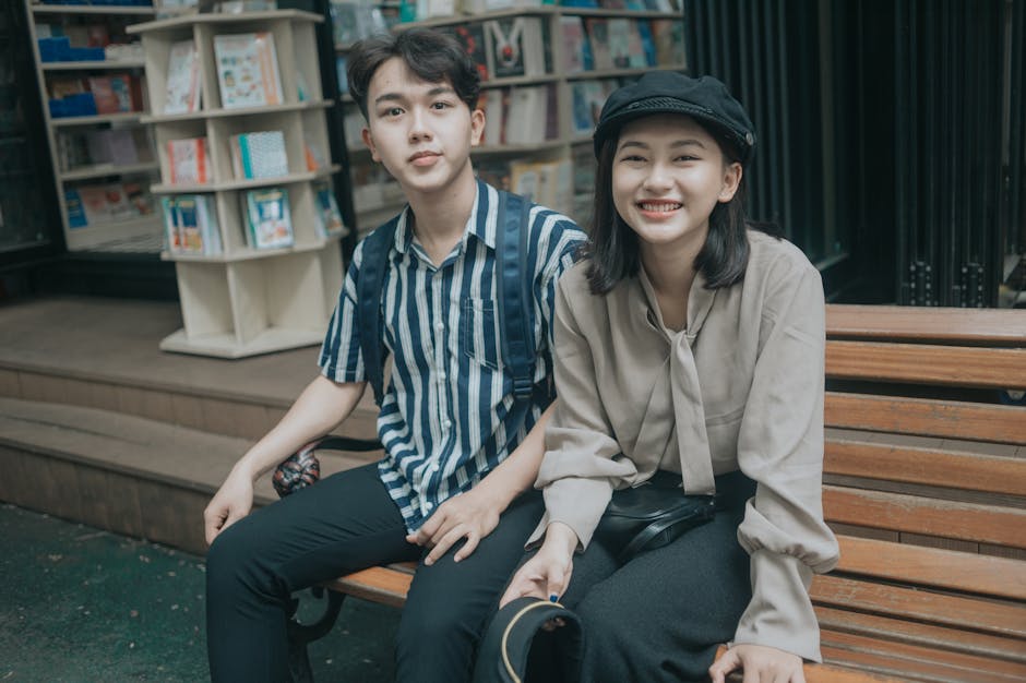 Happy couple sitting together on a bench outdoors in Gia Lai, Vietnam.